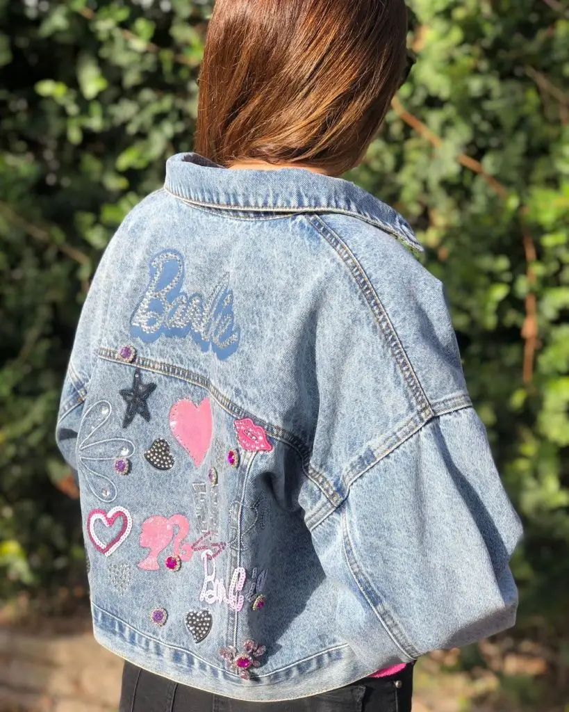 Dark-wash denim jacket depicting vivid galaxy-themed hand-painted art