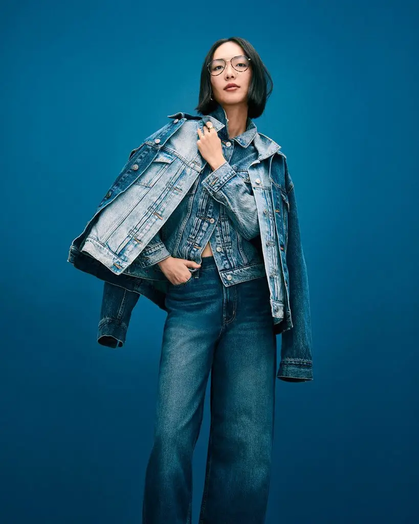 Denim jacket with metallic studs outlining the pockets and shoulders
