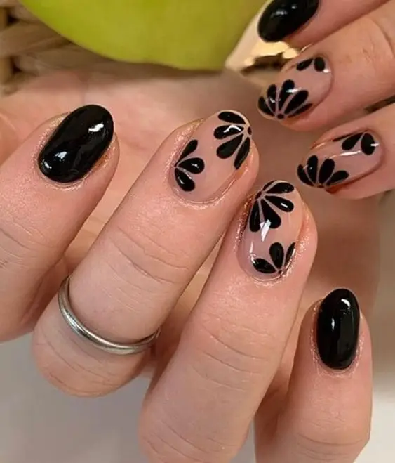 Shiny black nails with pink heart-shaped tips