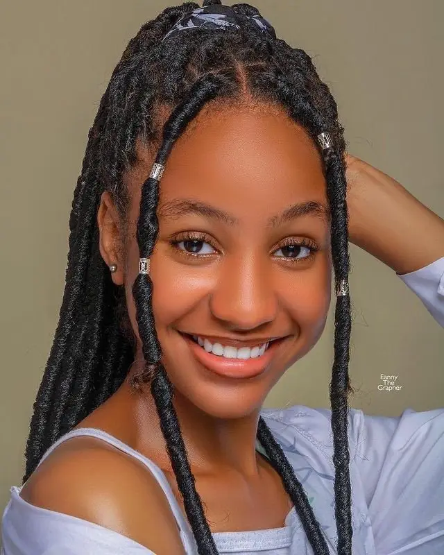 Goddess cornrows enhanced with subtle feed-in color highlights