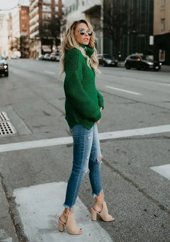 Casual green knit top with distressed denim for a laid-back Saint Patrick's Day outfit