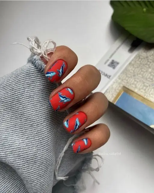 Valentine’s Day nails with a repeating heart pattern and pale pink backdrop