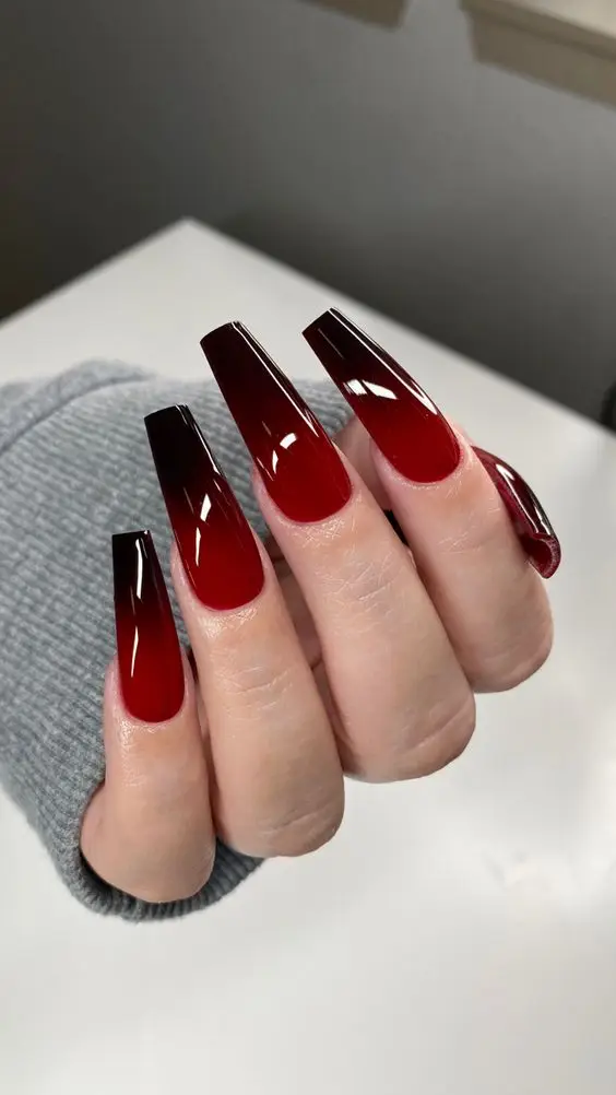 Glossy black nails featuring tiny pink and white dotted hearts