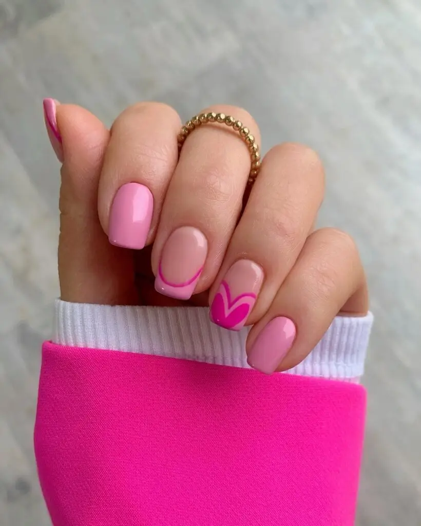 Pink Valentine’s nails with white heart and polka dot accents