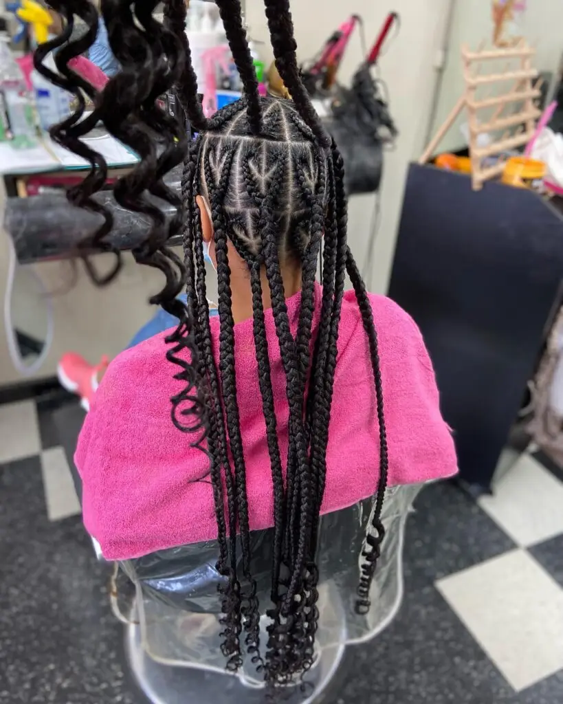 Goddess cornrows styled into a high braided ponytail with defined edges