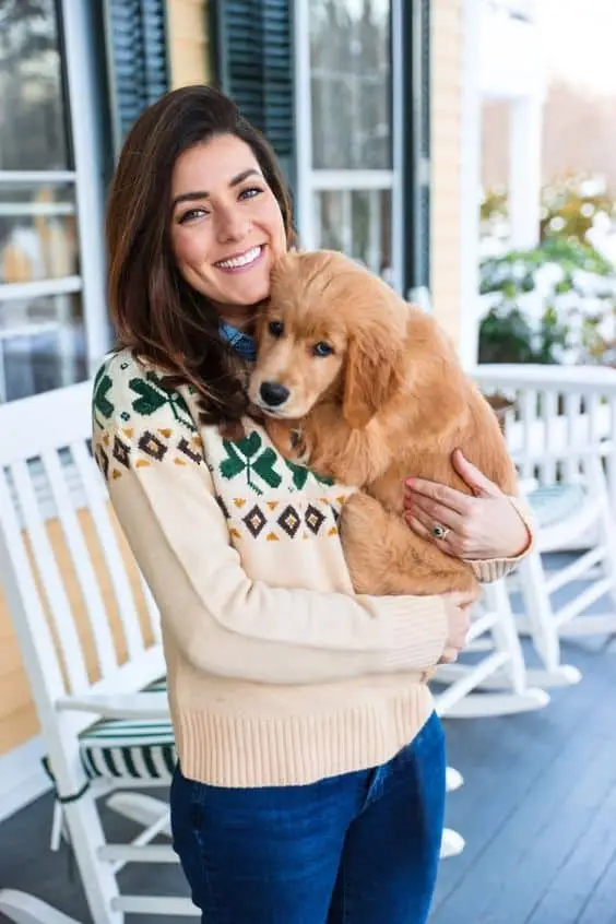 Chunky green cardigan layered over a graphic T-shirt and jeans for a laid-back look