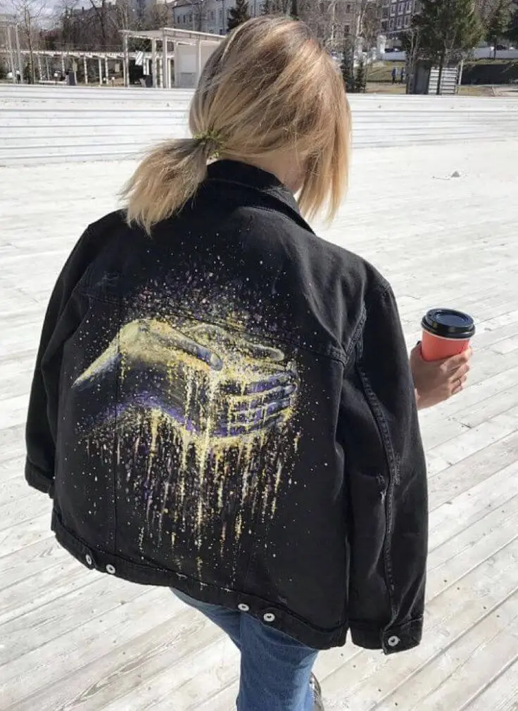 Denim jacket with handwritten white script text