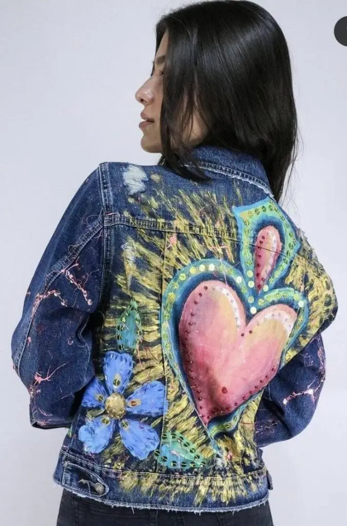 Medium-wash denim jacket with elegant black lace overlay details