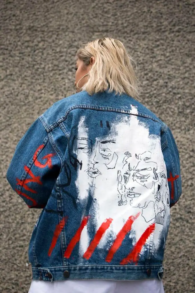 Denim jacket adorned with colorful geometric beading on the back panel