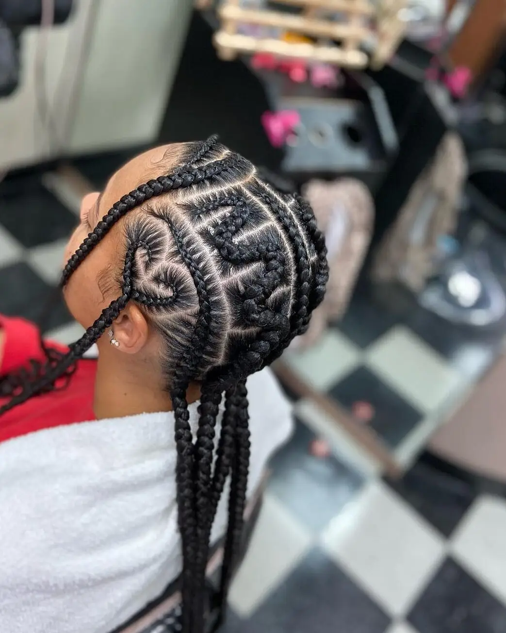 Goddess cornrows featuring artistic heart-shaped braiding patterns