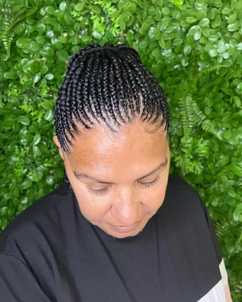 Elegant goddess cornrows adorned with beads and sleek braiding pattern