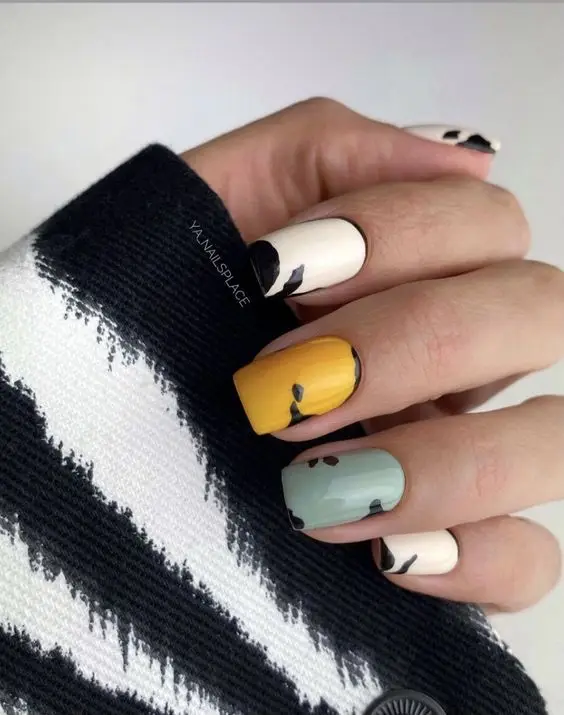 Black and red Valentine's Day nail art with heart details and glossy finish