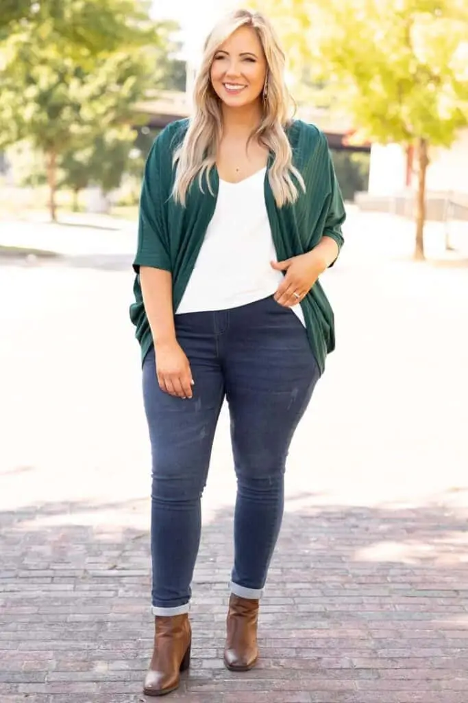 Olive green trench coat layered over a neutral outfit for Saint Patrick's Day look