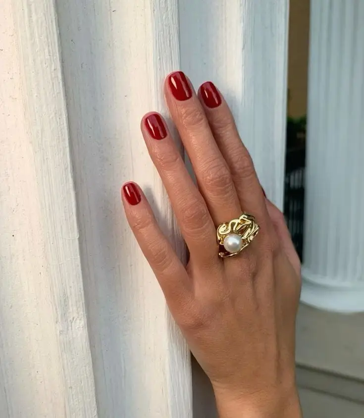 Embossed floral patterns on light beige nails