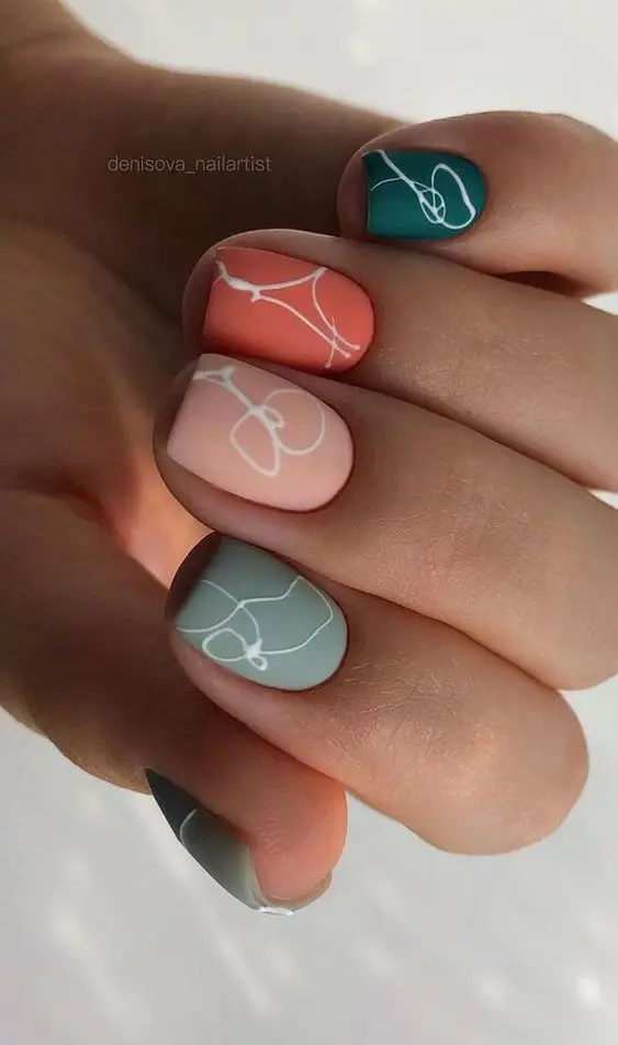 Valentine’s Day nails with pink glitter hearts and milky white base