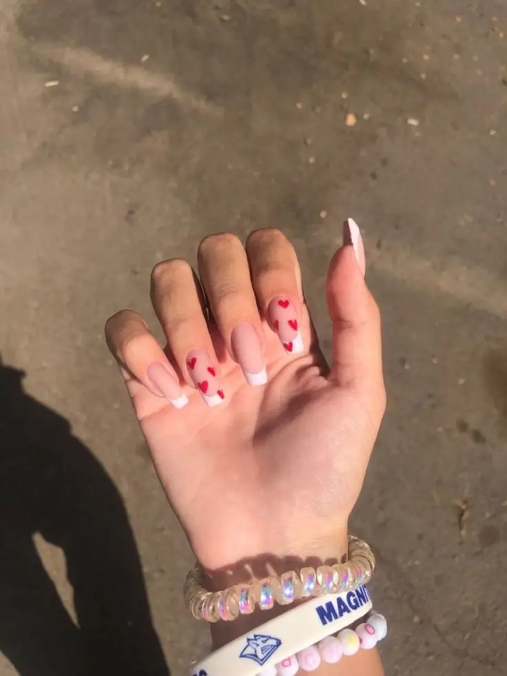 Modern French nails with pink heart-shaped tips for Valentine’s Day
