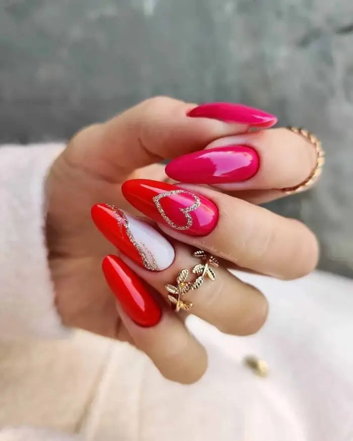 Glossy Red Almond Nails with Glitter Heart Tips