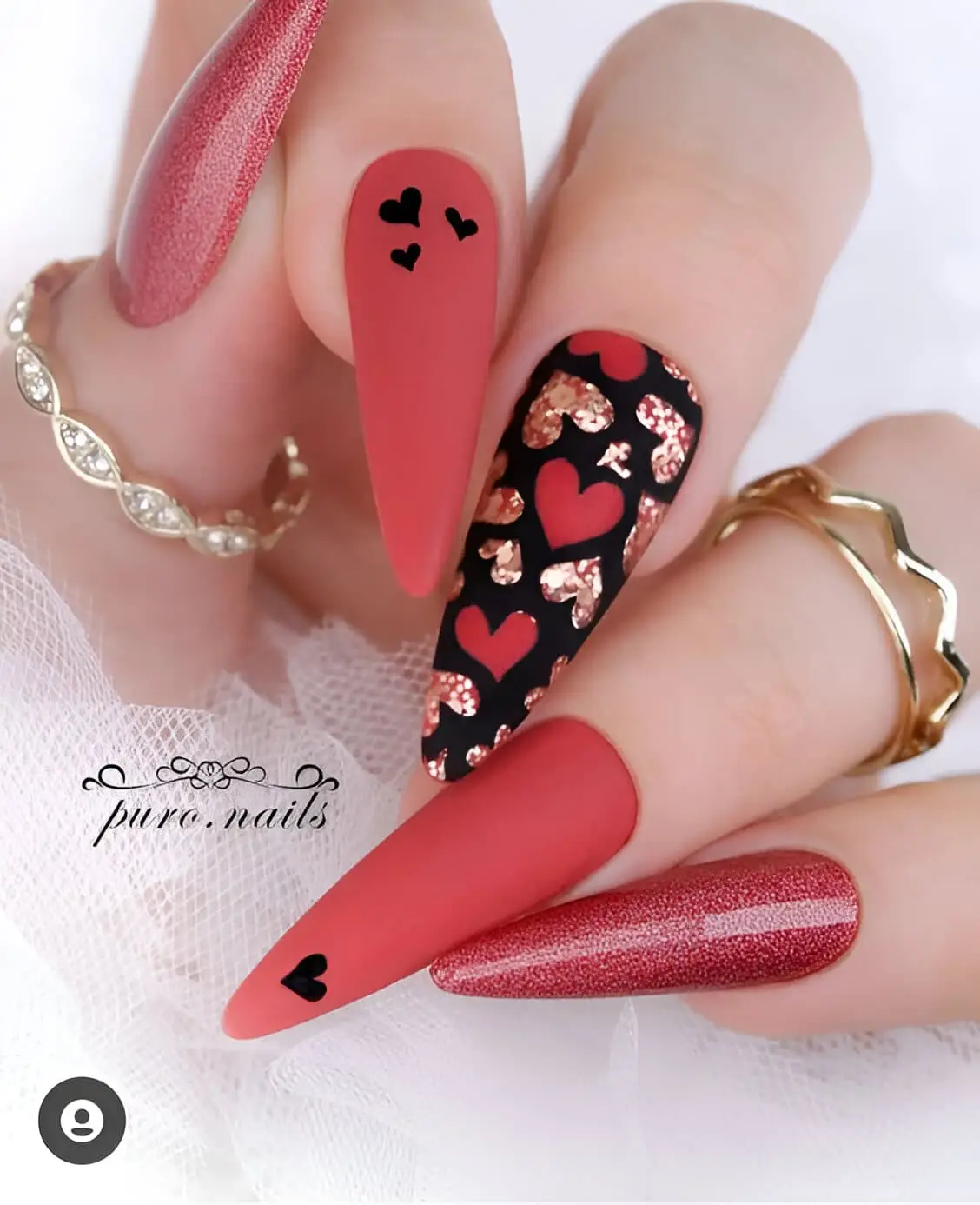 Red and white acrylic Valentine’s nails with bold geometric accents