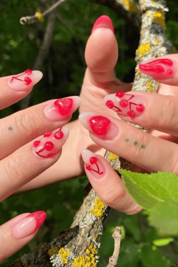 Elegant red acrylic nails with dainty gold accents for Valentine’s Day