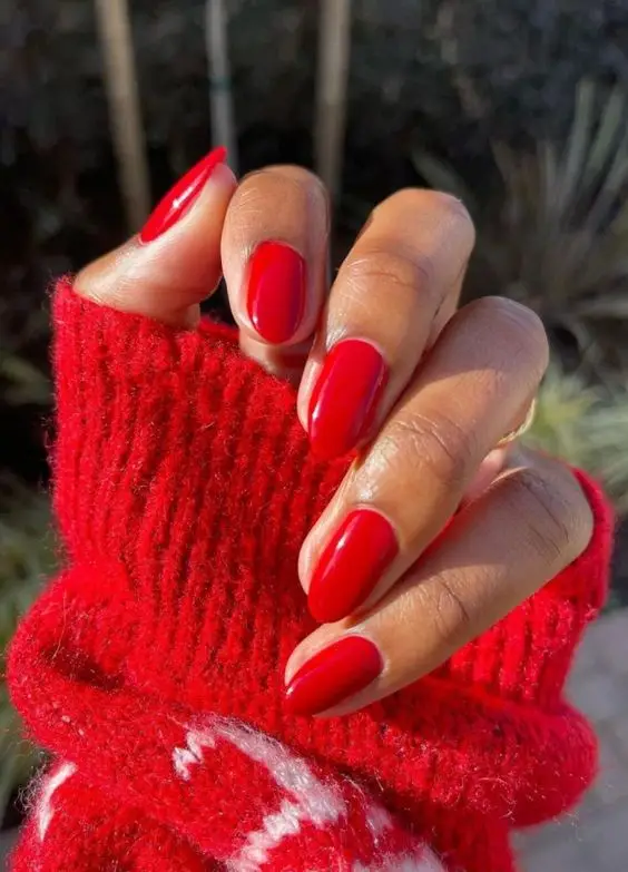 Red glitter ombre nails with a glossy finish