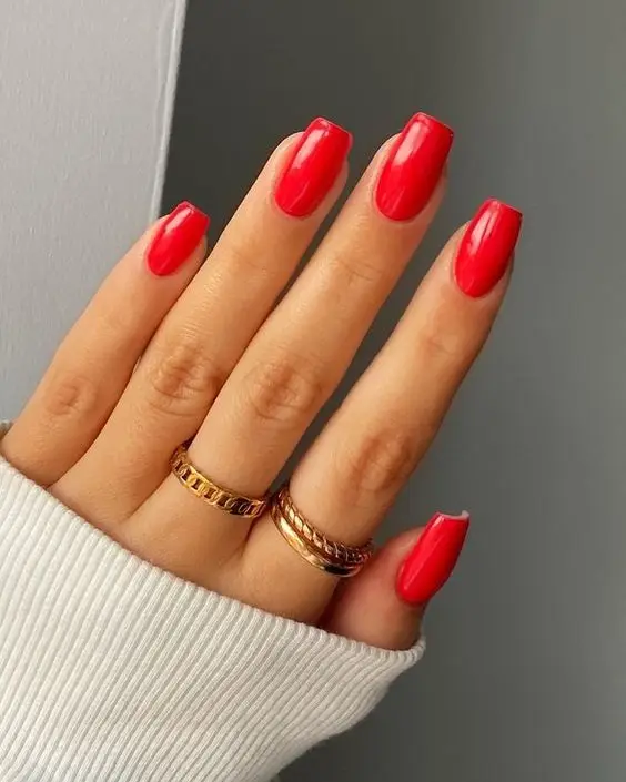 Bright red nails with bold heart graphic accents