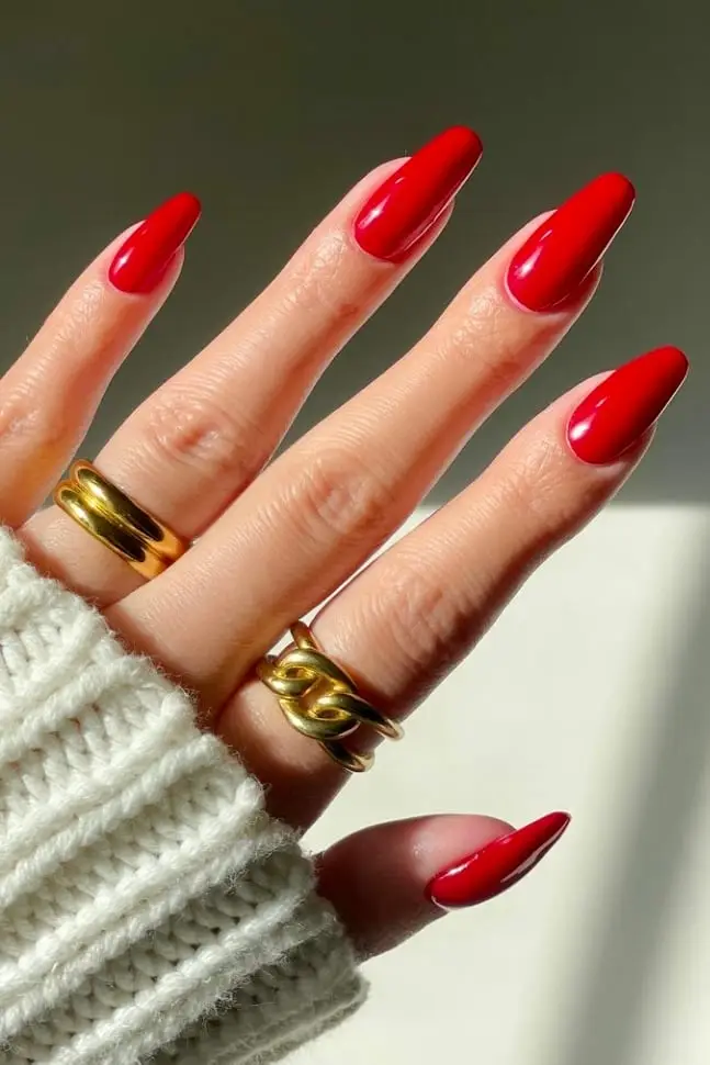 Glossy red nails with minimalist heart accents