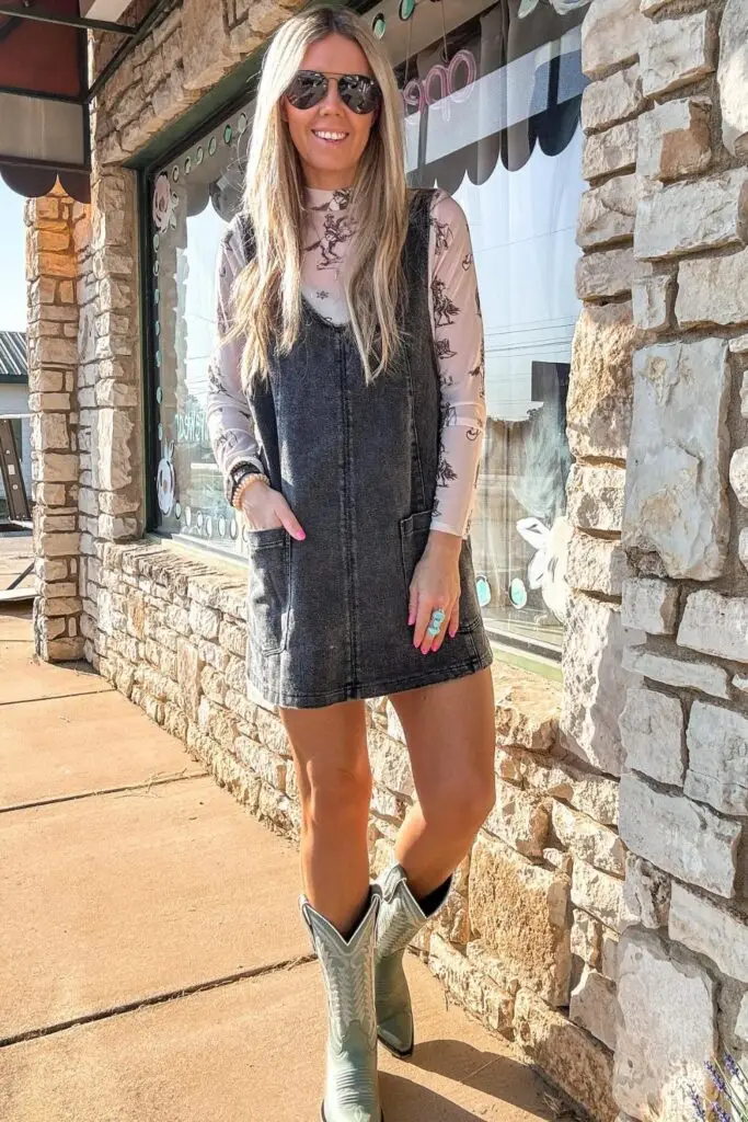 Woman in flared jeans, leather vest, and cowboy hat