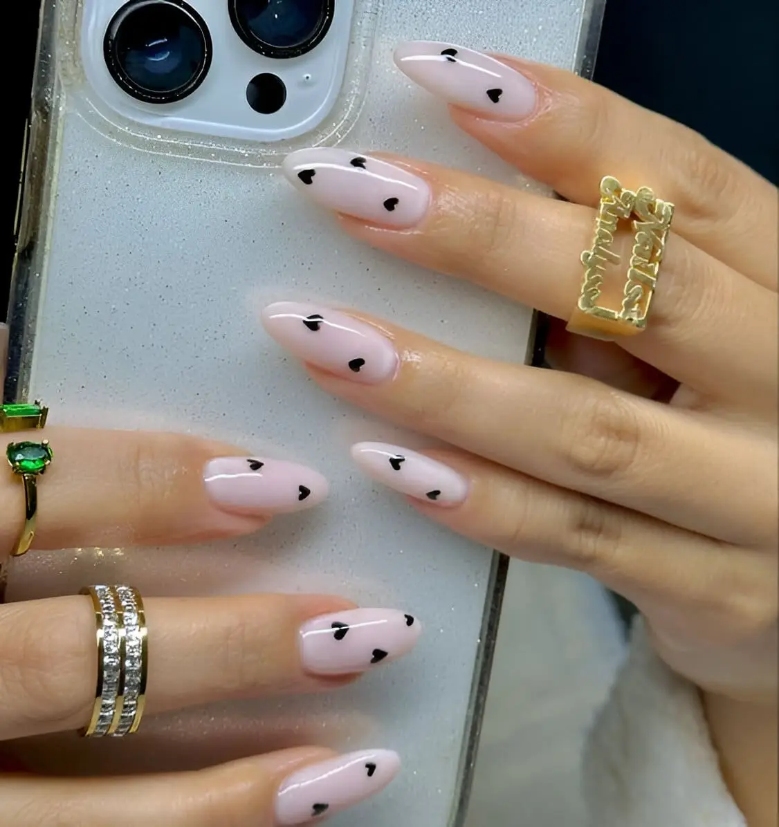 White Valentine’s acrylic nails with subtle heart details and a matte finish