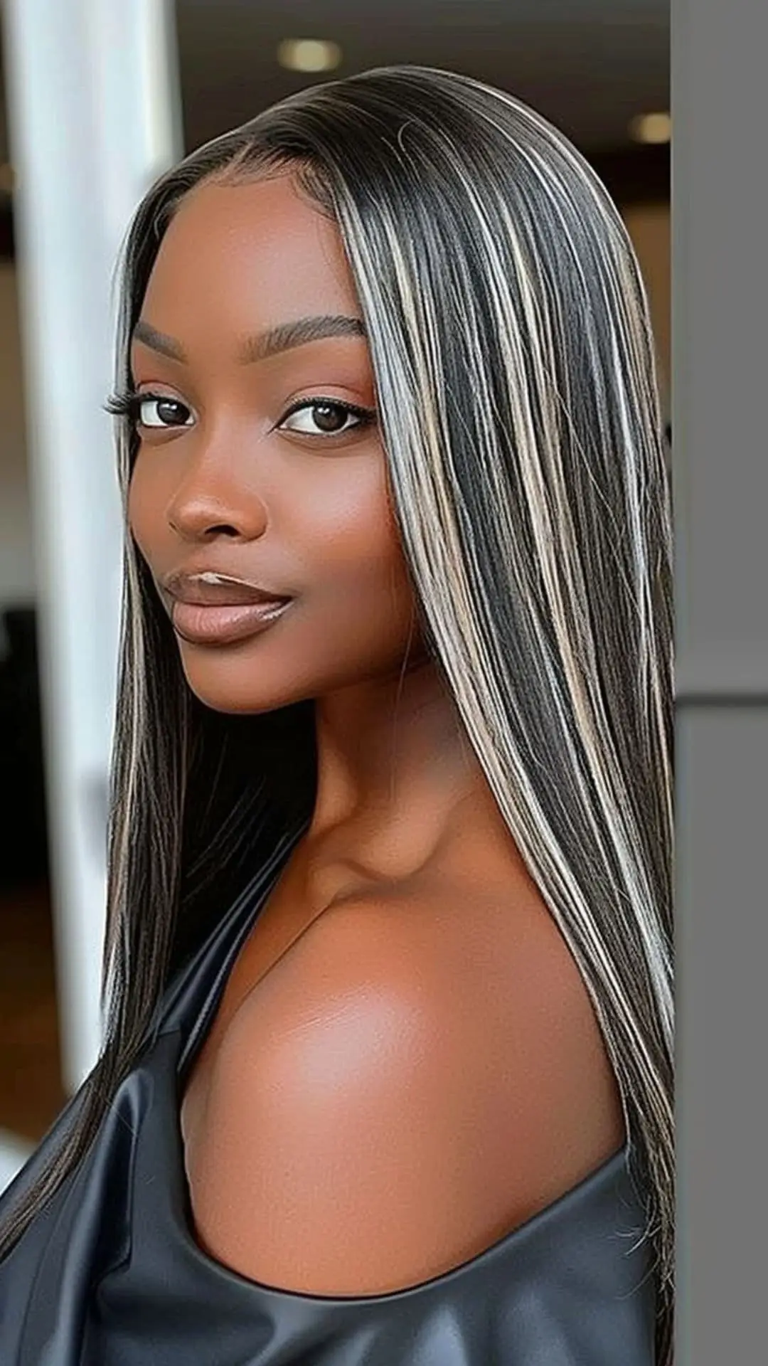 Jet-black hair with bright platinum blonde highlights adding a dramatic flair