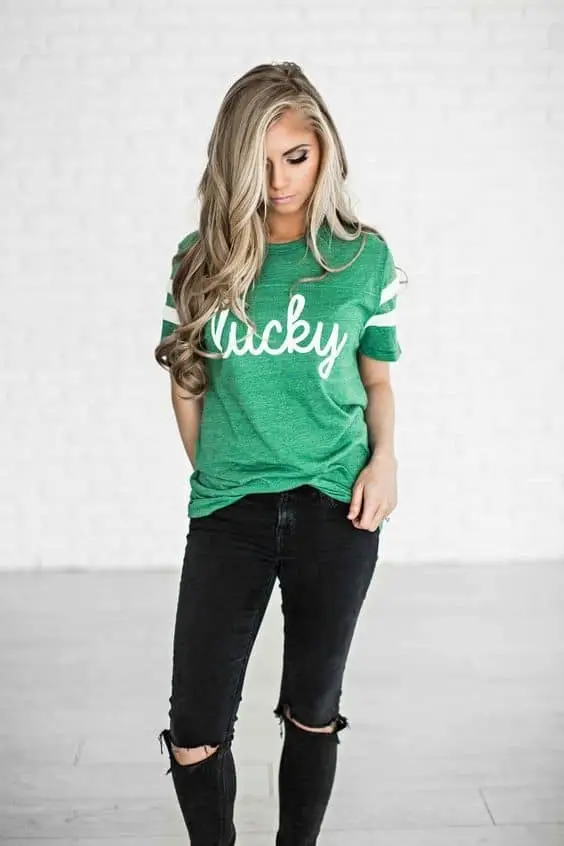 Light green tee with a statement jacket and ripped denim jeans