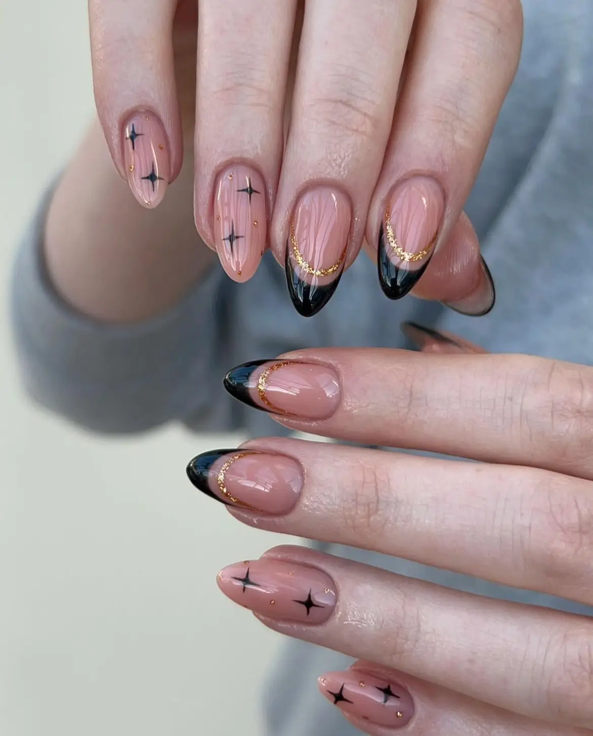 Matte black nails with silver gem placement for a chic look