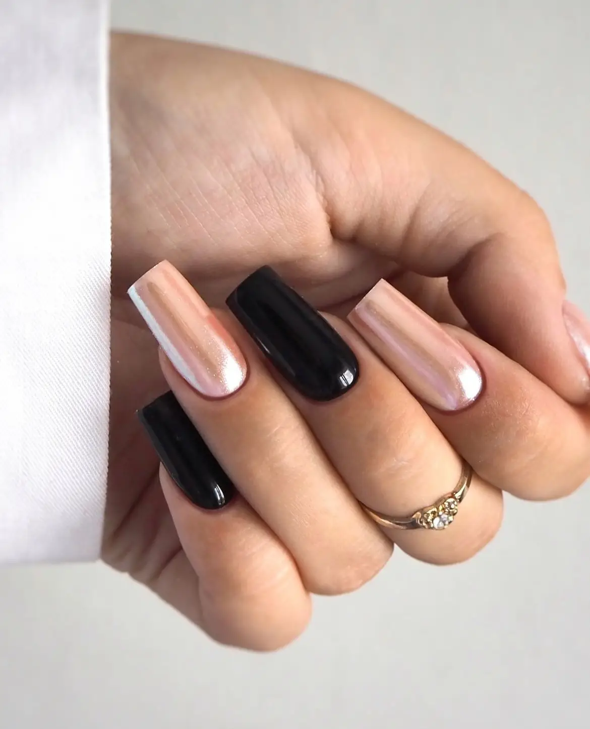 Black French tip nails with silver glitter accents