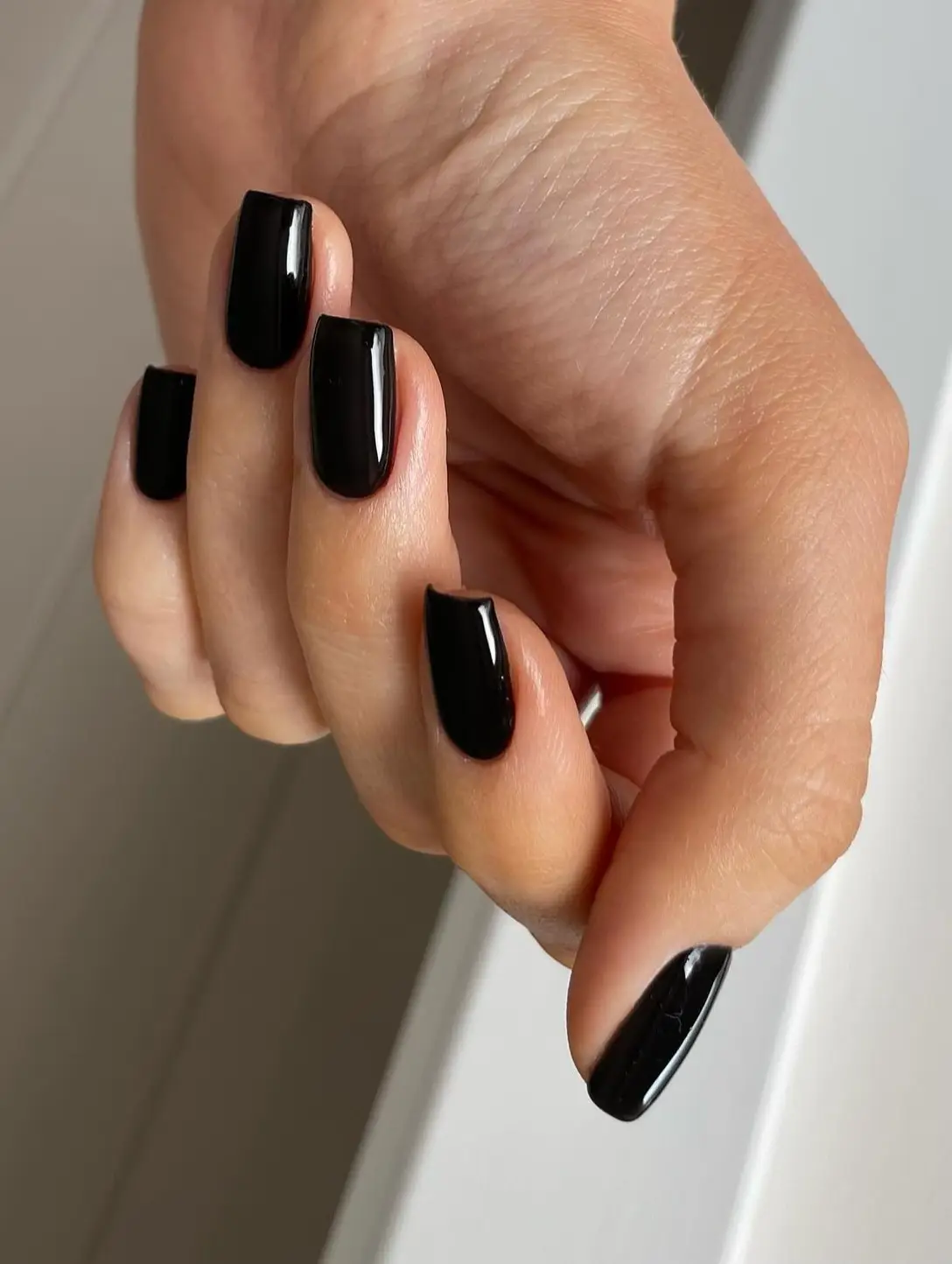 Matte black nails with dark, detailed floral art