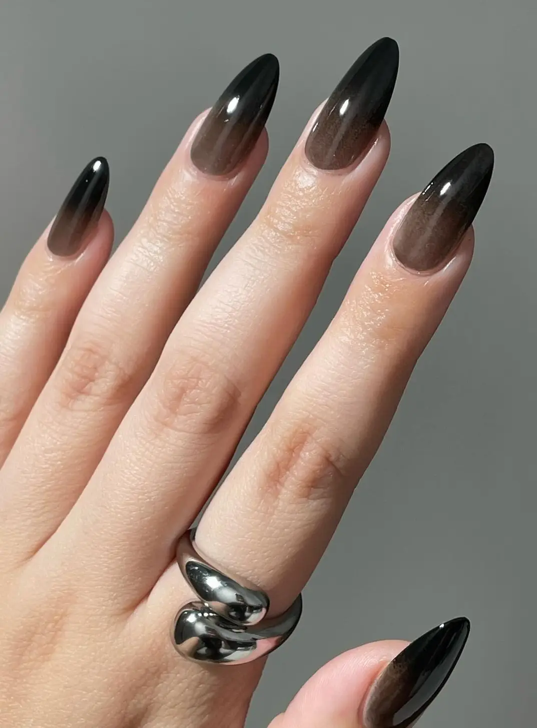 Glossy black nails with bold red rose accents