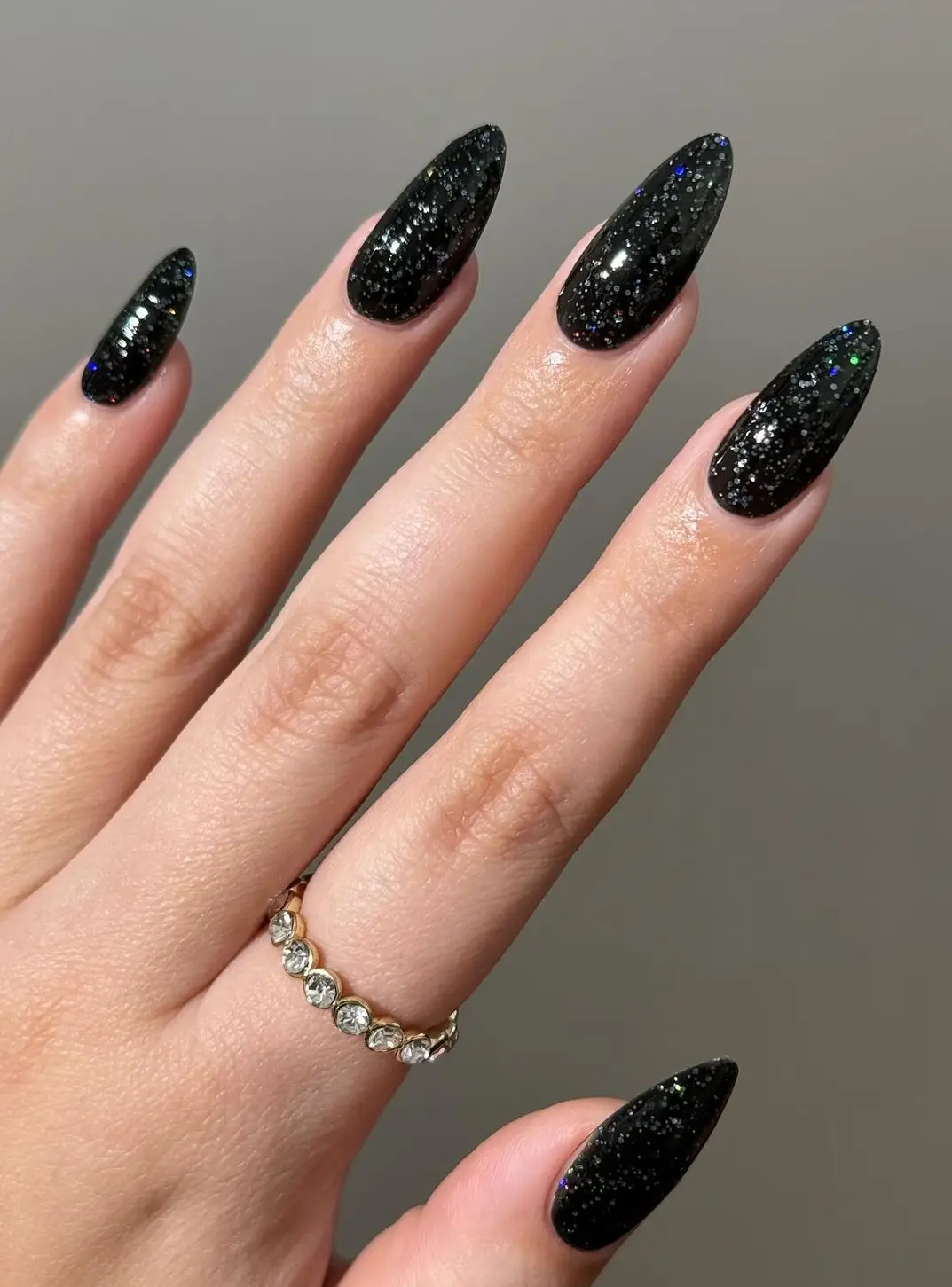 Black nails with bold red flame designs along the tips