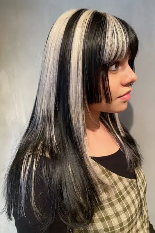 Black hair with dramatic blonde color blocking for a bold, edgy effect