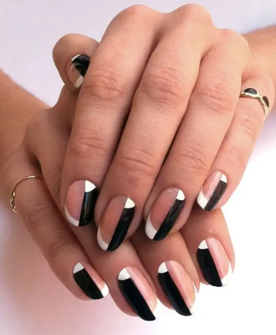 Black nails with metallic heart accents in pink