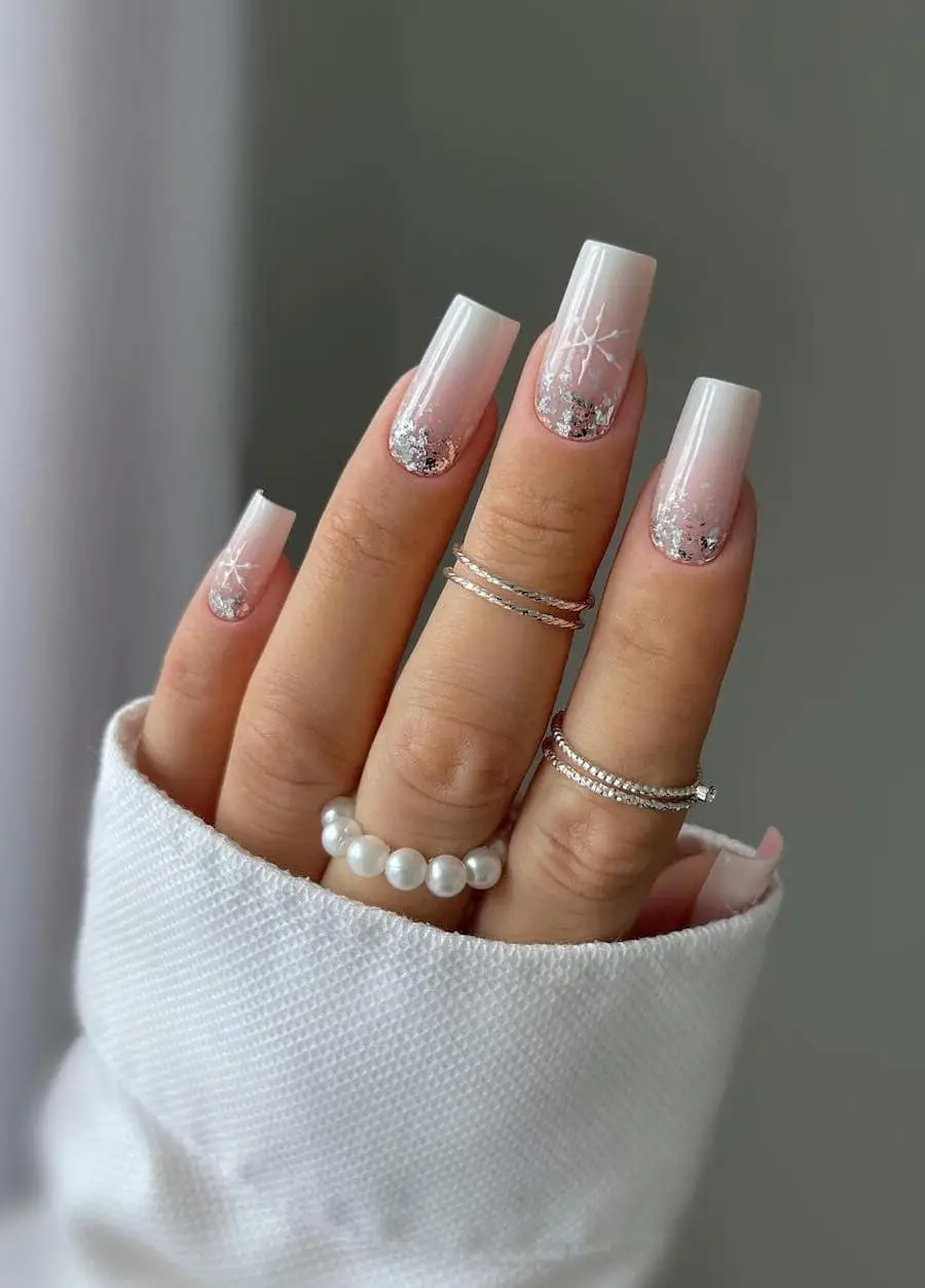 Christmas-themed red and white nails featuring delicate ribbon-inspired designs