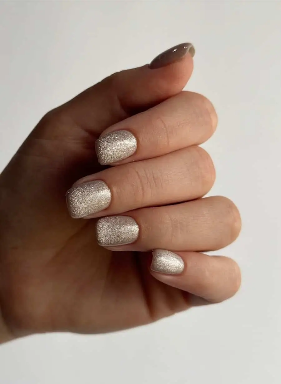 Holiday-inspired nails featuring red, silver glitter, and snowflake details