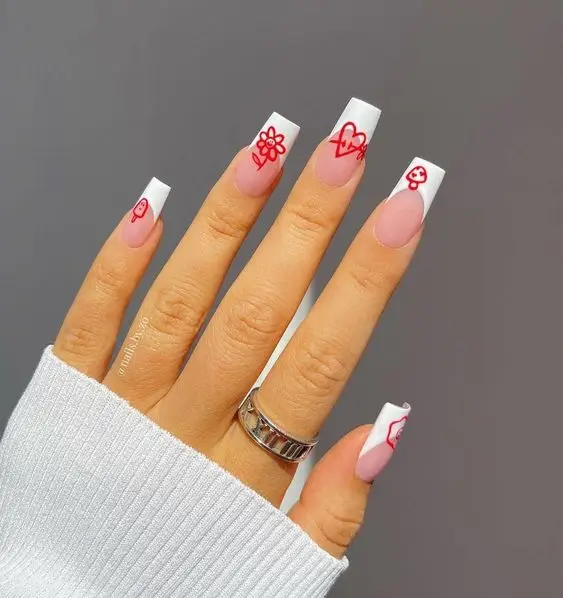 Bold Cupid-themed Valentine’s nails with graphic arrows and hearts