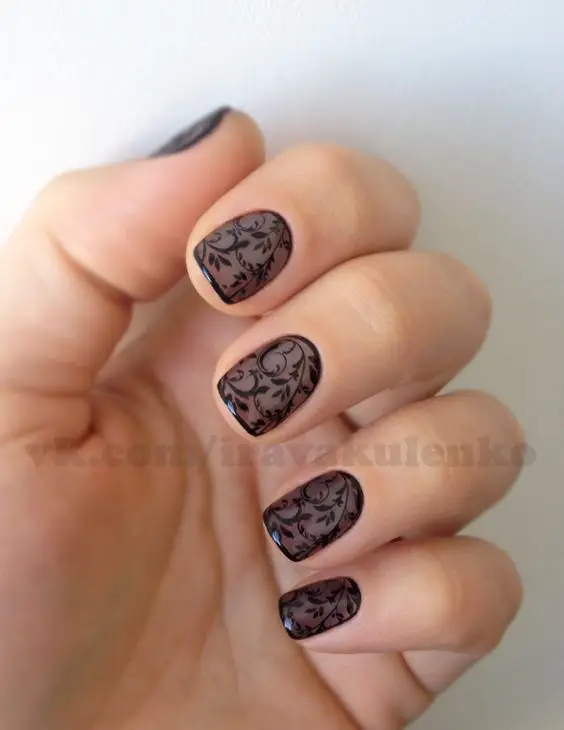 Glossy black nails with intricate white rose designs