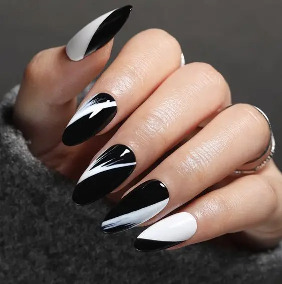 Shiny black nails with silver chrome heart-shaped tips
