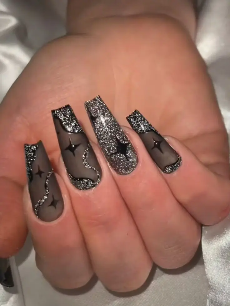 Shiny black nails with heart-shaped crystal embellishments