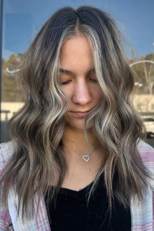 Black hair with bold, face-framing blonde highlights for a striking contrast