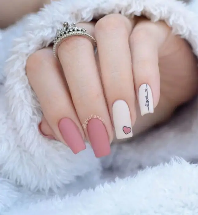 Matte nude nails with raised heart accents for Valentine's Day
