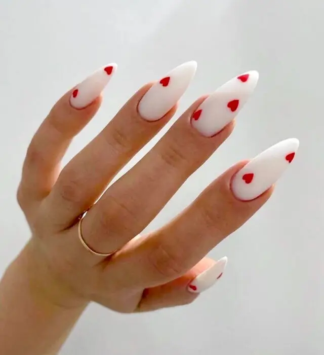 Clear Valentine’s nails with red hearts and glitter