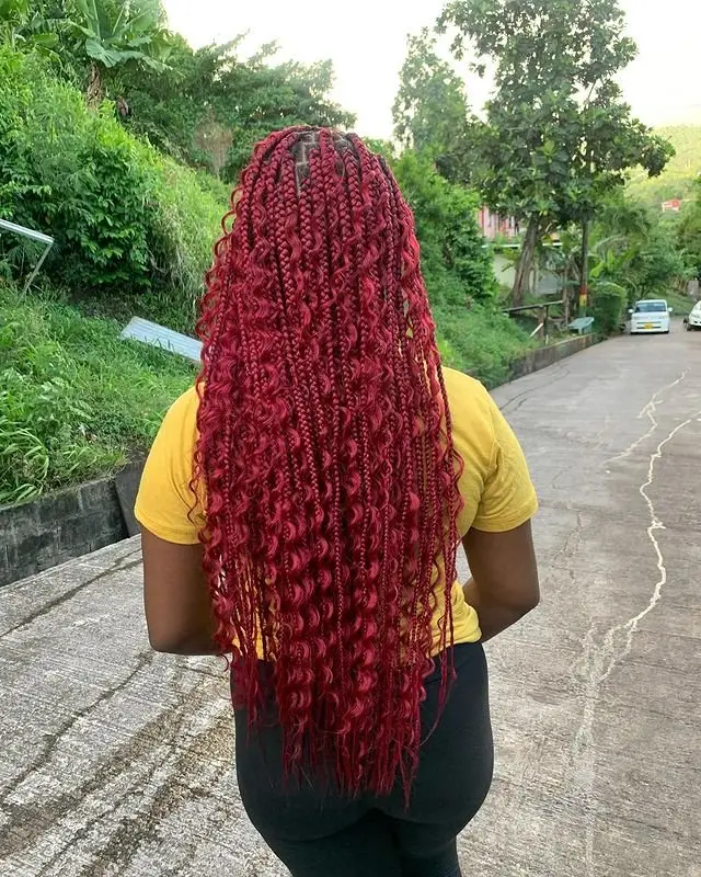 Goddess cornrows with an asymmetrical design featuring a twisted side accent