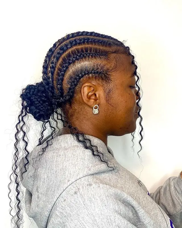 Goddess cornrows transitioning into free-flowing, voluminous curls