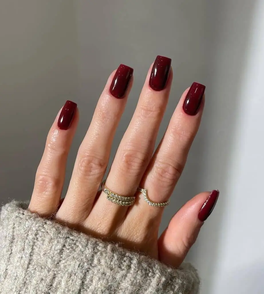 Neutral nails with golden shimmer accents and glossy finish