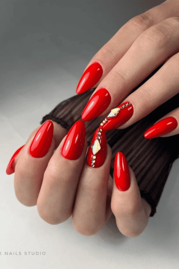 Red Valentine’s acrylic nails with 3D rose accents and a glossy finish
